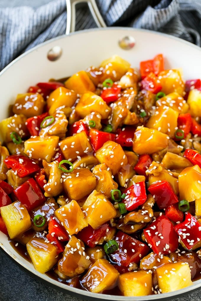 Pineapple Chicken | Hawaiian Chicken | Chicken Stir Fry #pineapple #chicken #dinner #stirfry #fuyos Pineapple chicken stir fry in a skillet, topped with sauce, sesame seeds and green onions.