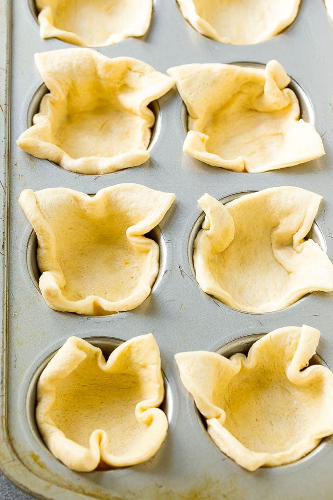 Pizza Muffins Recipe | Pizza Bites | Pizza Cups | Pizza Appetizer #pizza #appetizer #fuyos Crescent roll dough pressed into a tin forms the crust.
