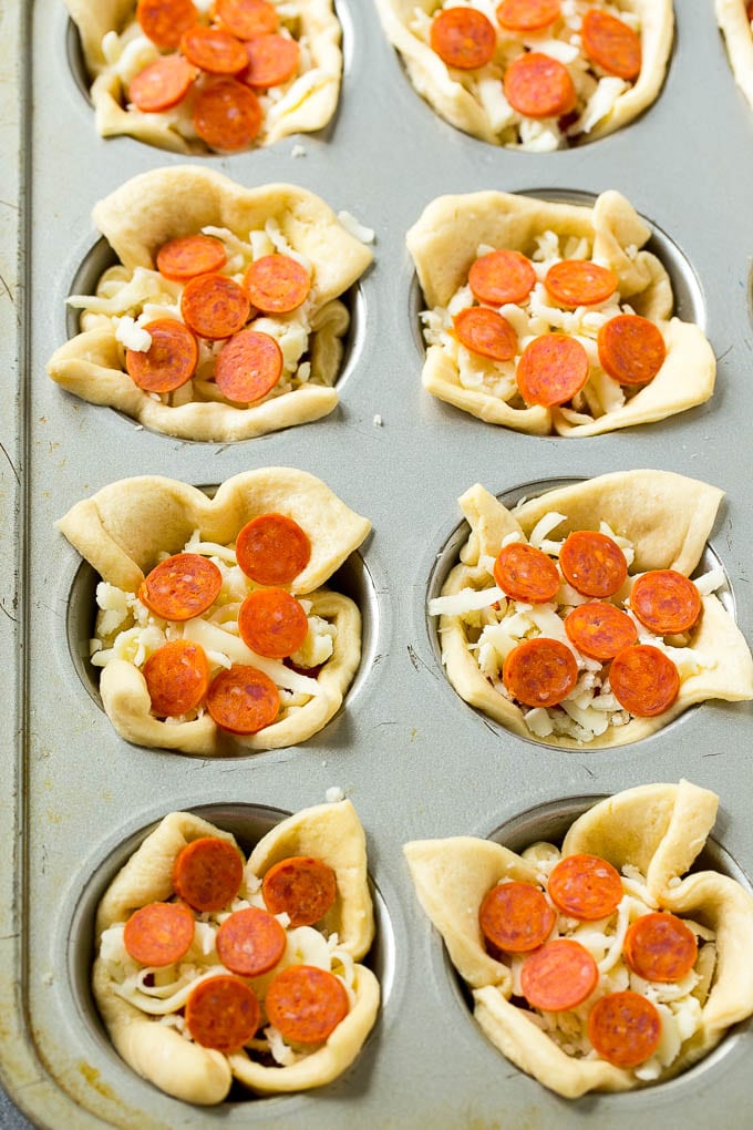 Pizza Muffins Recipe | Pizza Bites | Pizza Cups | Pizza Appetizer #pizza #appetizer #fuyos Unbaked dough cups filled with cheese, sauce and pepperoni.