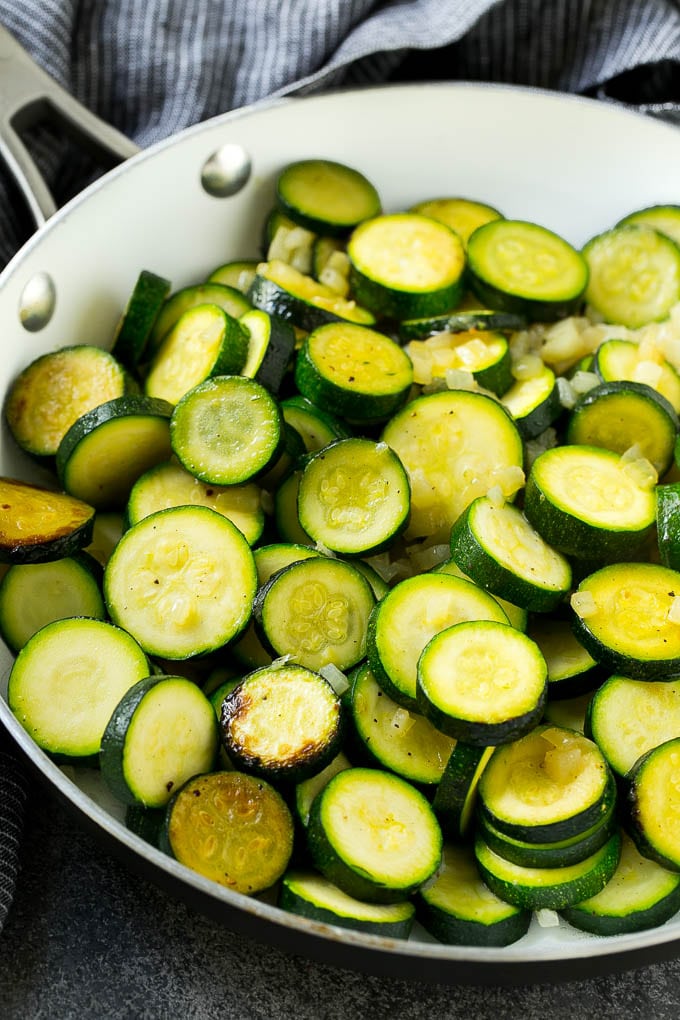 Zucchini Gratin Recipe | Cheesy Zucchini | Baked Zucchini | Easy Zucchini Recipe #zucchini #casserole #cheese #dinner #sidedish #fuyos Sauteed zucchini and onions in a skillet.