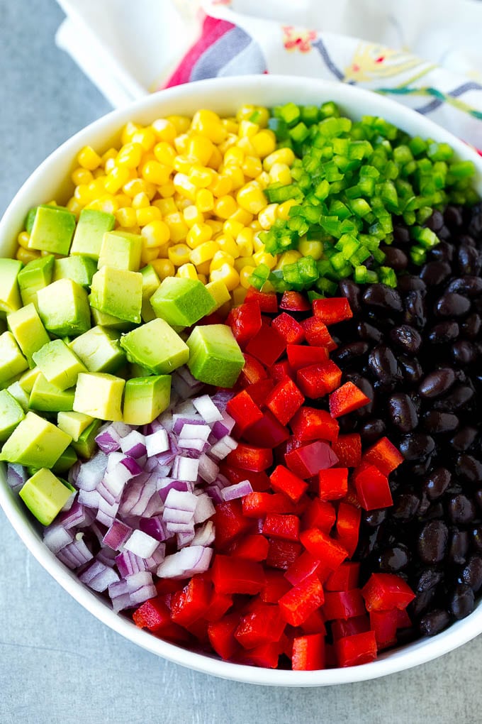 Black Bean and Corn Salad Recipe | Mexican Salad | Black Bean Salad | Bean Salad #salad #beans #corn #mexicanfood #fuyos A bowl of beans, corn, diced red peppers, minced jalapeno, red onion and avocado.