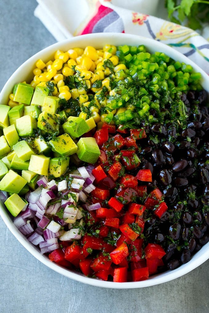 Black Bean and Corn Salad Recipe | Mexican Salad | Black Bean Salad | Bean Salad #salad #beans #corn #mexicanfood #fuyos Black beans, corn and assorted vegetables topped with cilantro lime dressing.