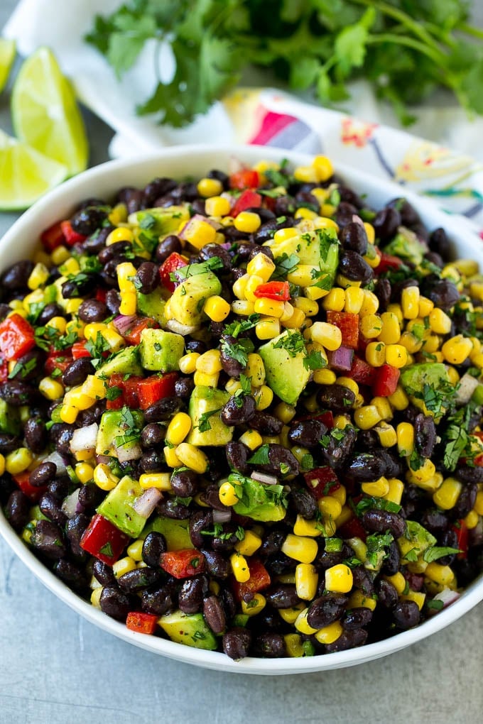 Black Bean and Corn Salad Recipe | Mexican Salad | Black Bean Salad | Bean Salad #salad #beans #corn #mexicanfood #fuyos A serving bowl of black bean salad with corn, peppers and avocado.