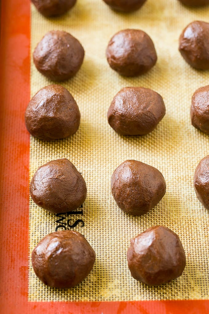 Nutella Cookies Recipe | Nutella Stuffed Cookies | Chocolate Cookies #nutella #chocolate #cookies #baking #dessert #fuyos Balls of chocolate cookie dough on a baking sheet.