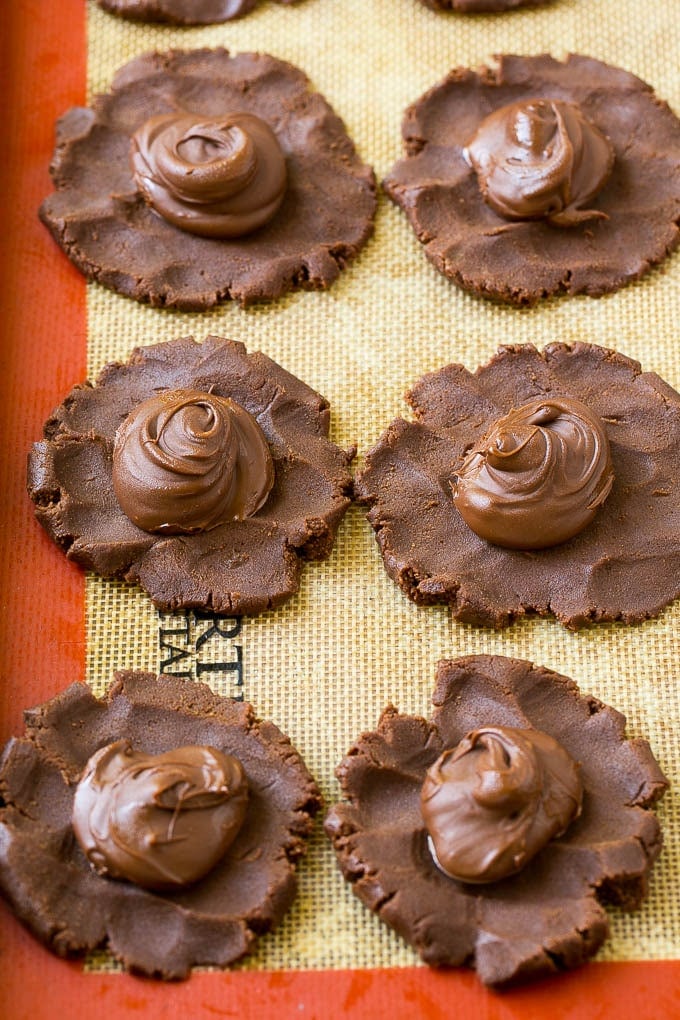 Nutella Cookies Recipe | Nutella Stuffed Cookies | Chocolate Cookies #nutella #chocolate #cookies #baking #dessert #fuyos Cookie dough with dollops of nutella in the center.