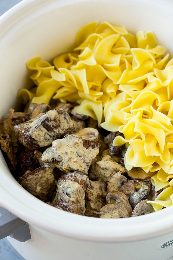 Slow Cooker Beef Stroganoff Recipe | Crock Pot Beef Stroganoff | Beef Recipe #slowcooker #crockpot #beef #mushrooms #pasta #dinner #fuyos Beef in a creamy sauce and egg noodles in a slow cooker.