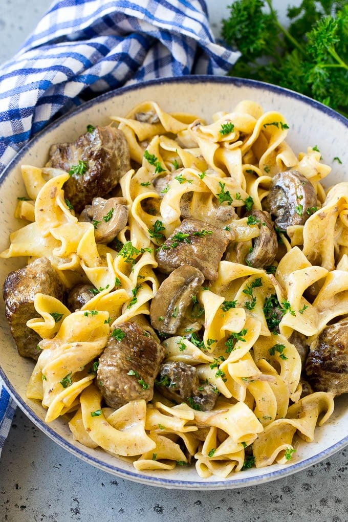Slow Cooker Beef Stroganoff Recipe | Crock Pot Beef Stroganoff | Beef Recipe #slowcooker #crockpot #beef #mushrooms #pasta #dinner #fuyos A bowl of slow cooker beef stroganoff with egg noodles.