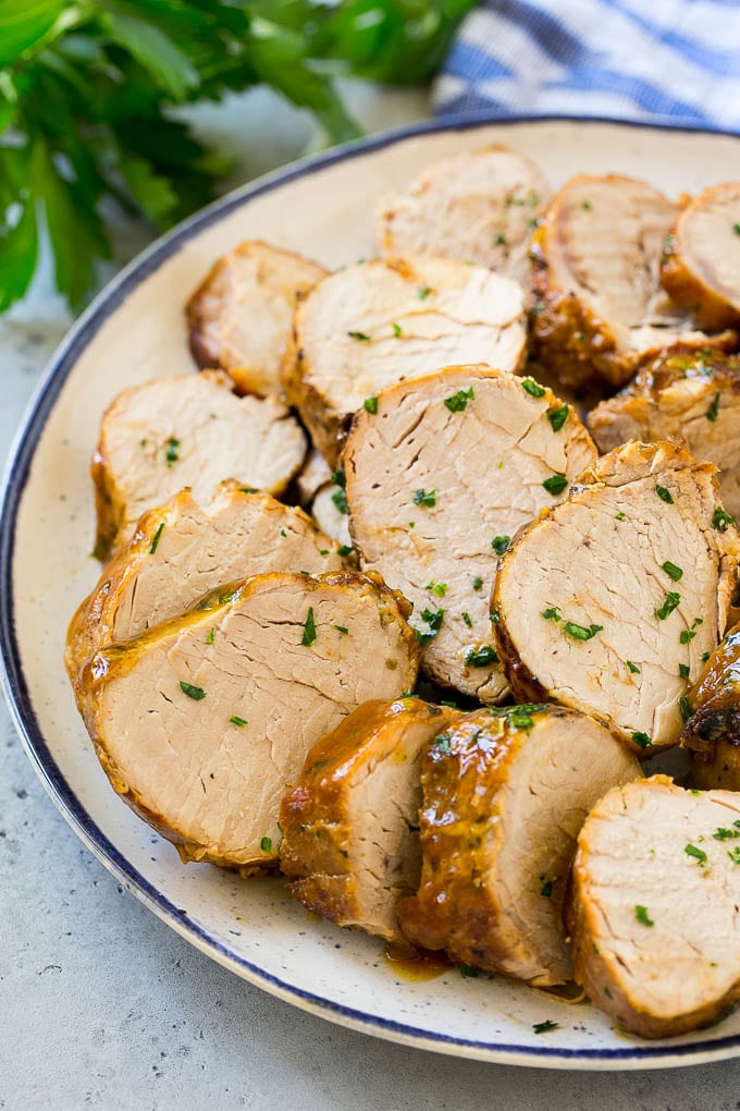 Slow Cooker Pork Tenderloin Recipe | Crock Pot Pork Tenderloin | Easy Pork Tenderloin #slowcooker #crockpot #pork #dinner #fuyos Sliced slow cooker pork tenderloin on a plate.
