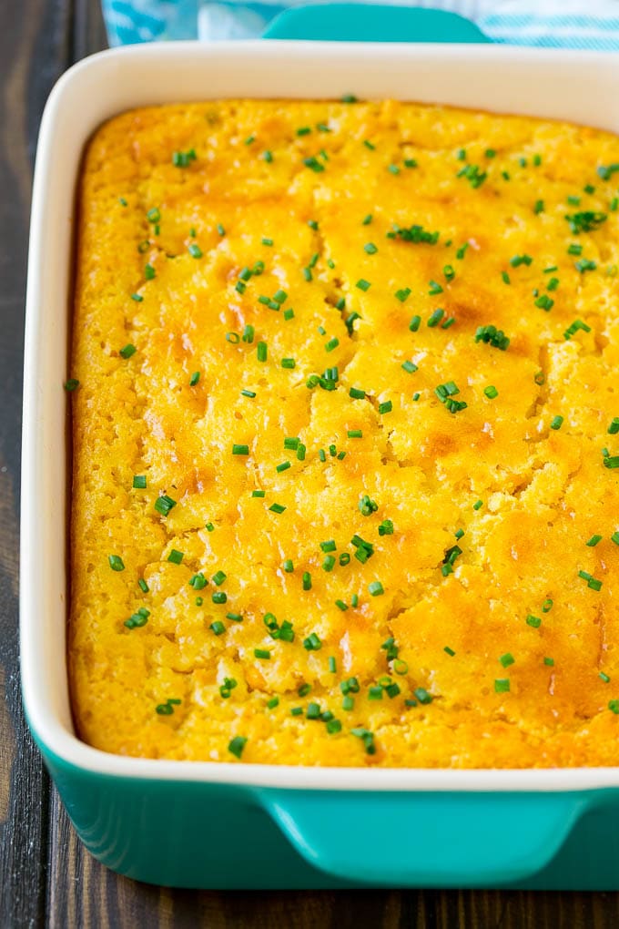 Corn Pudding Recipe | Corn Casserole | Corn Side Dish #corn #pudding #casserole #sidedish #thanksgiving #dinner #fuyos A casserole dish of corn pudding topped with chives.