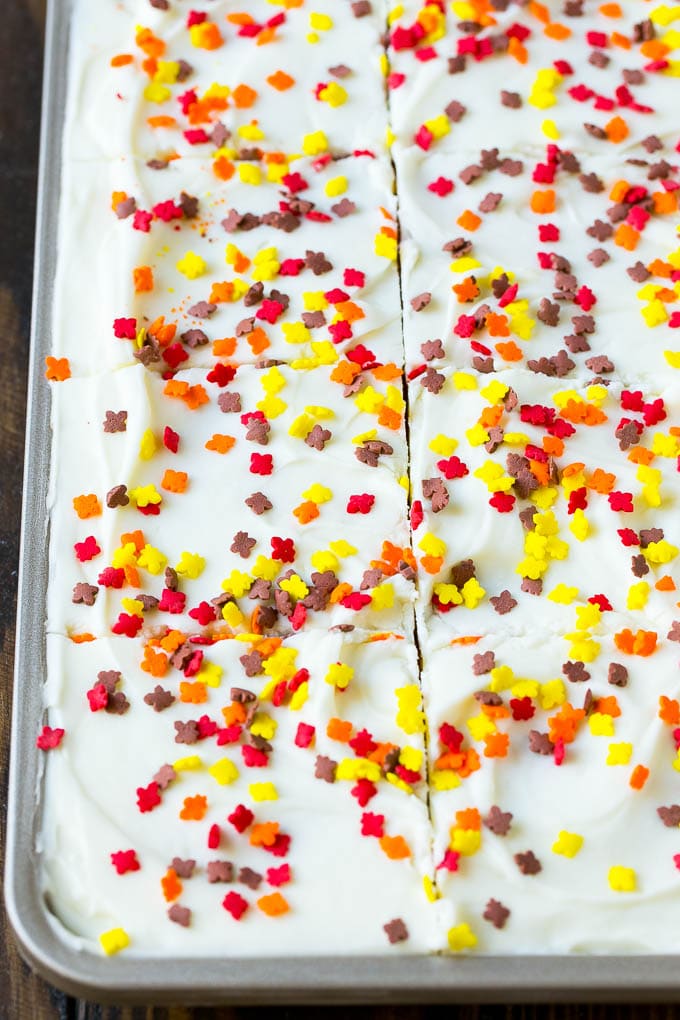 Pumpkin Bars Recipe | Pumpkin Cake | Pumpkin Dessert #pumpkin #fall #dessert #fuyos #thanksgiving Cream cheese frosting and sprinkles spread over cake.