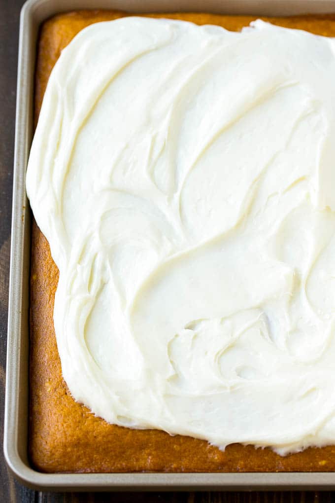 Pumpkin Bars Recipe | Pumpkin Cake | Pumpkin Dessert #pumpkin #fall #dessert #fuyos #thanksgiving Cream cheese frosting spread over cake.
