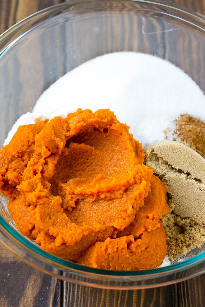 Pumpkin Bars Recipe | Pumpkin Cake | Pumpkin Dessert #pumpkin #fall #dessert #fuyos #thanksgiving Pumpkin puree, brown sugar and flour in a bowl.