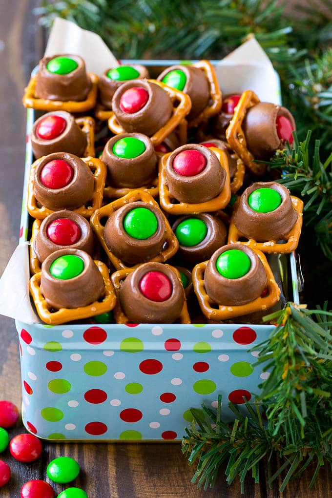 Rolo Pretzels Recipe | Chocolate Pretzels | Caramel Pretzels | Holiday Candy #christmas #baking #dessert #candy #chocolate #caramel #pretzels #fuyos A gift tin full of Christmas colored Rolo pretzels.