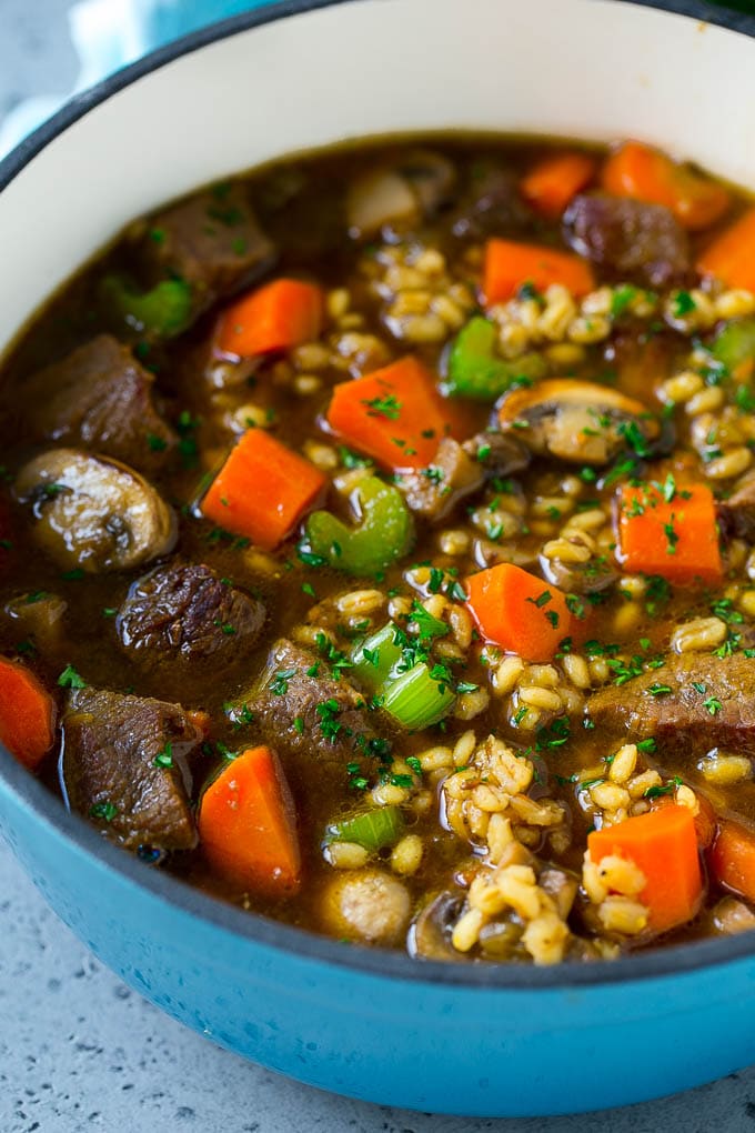 Beef Barley Soup Recipe | Beef Soup | Barley Soup #soup #beef #dinner #vegetables #fuyos #comfortfood A pot of beef barley soup with mushrooms, carrots and celery.