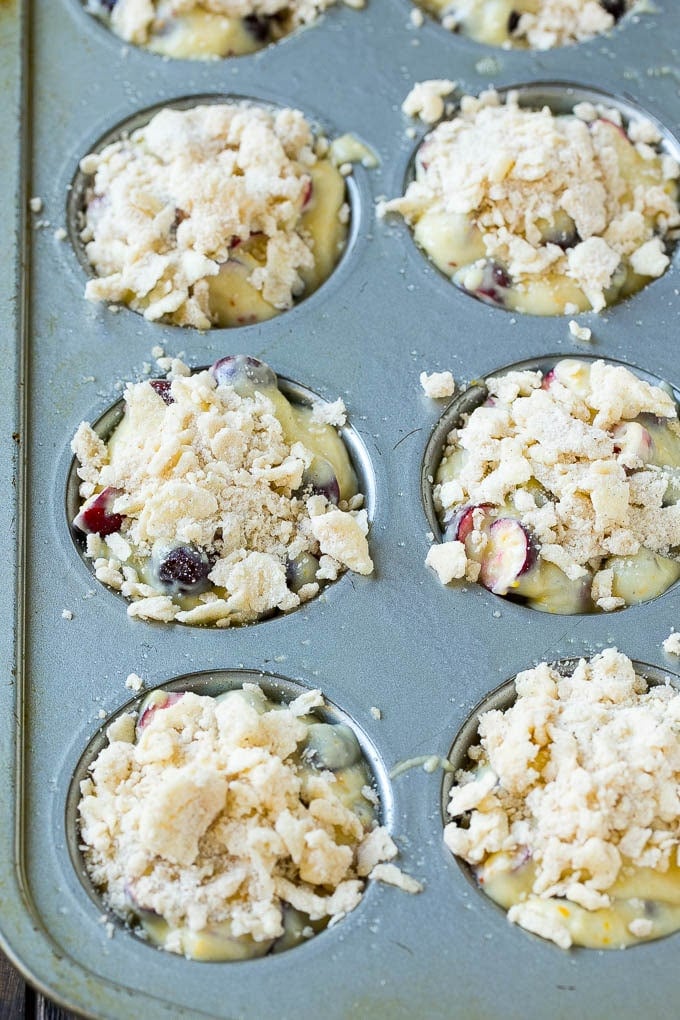 Cranberry Muffins Recipe | Cranberry Orange Muffins #cranberry #muffins #orange #fall #dessert #fuyos Muffins topped with streusel ready to go into the oven.