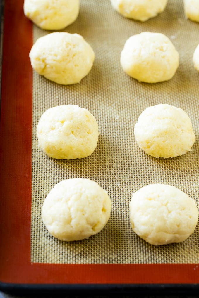Gooey Butter Cookies Recipe | Cake Mix Cookies | Sprinkle Cookies | Christmas Cookies #cookies #butter #sprinkles #christmas #dessert #baking #fuyos Balls of dough on a baking sheet.