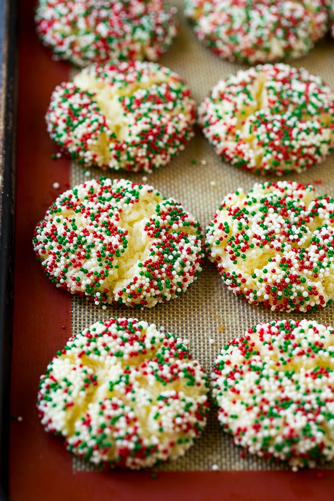 Gooey Butter Cookies Recipe | Cake Mix Cookies | Sprinkle Cookies | Christmas Cookies #cookies #butter #sprinkles #christmas #dessert #baking #fuyos Baked gooey butter cookies on a sheet pan.