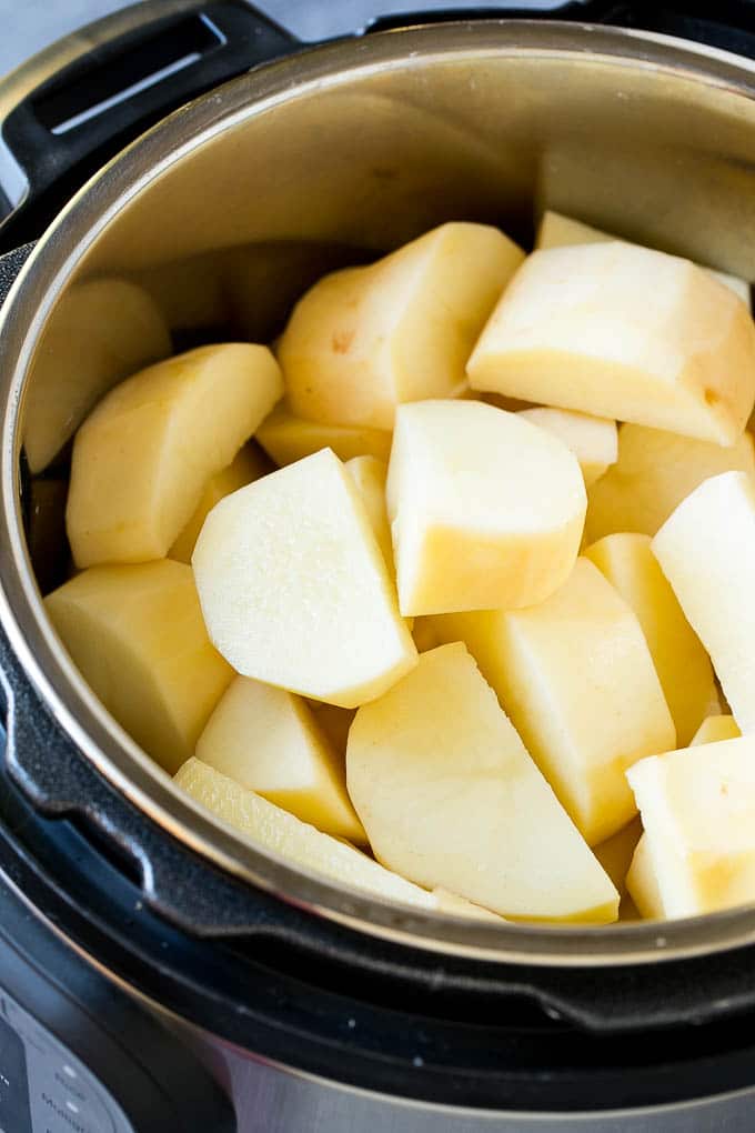 Instant Pot Mashed Potatoes Recipe | Pressure Cooker Mashed Potatoes | Easy Mashed Potatoes #potatoes #sidedish #instantpot #thanksgiving #dinner #fuyos Peeled potatoes in an Instant Pot.