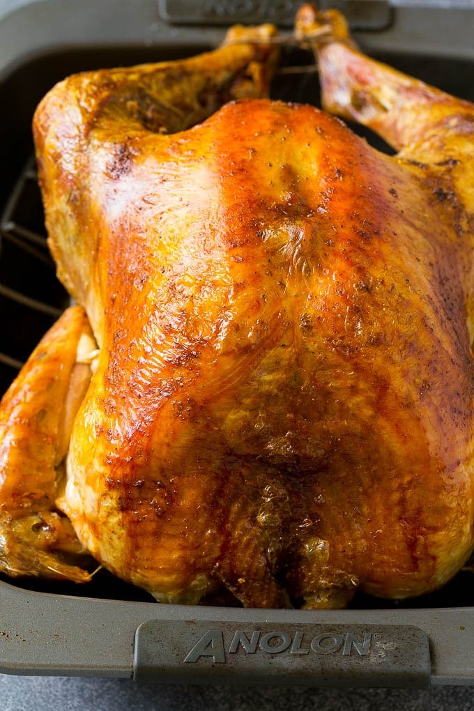Roast Turkey Recipe | Thanksgiving Turkey | Holiday Turkey | Baked Turkey #turkey #thanksgiving #christmas #dinner #glutenfree #fuyos A roasted turkey in a baking pan.