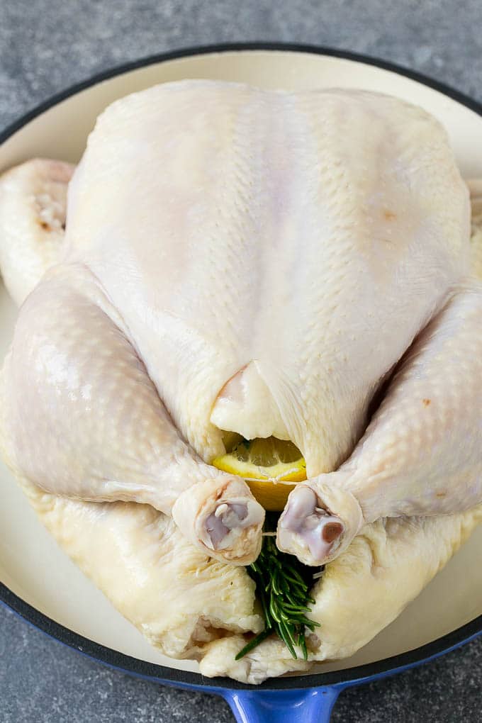 Roasted Chicken Recipe | Whole Roasted Chicken | Roast Chicken #chicken #dinner #lowcarb #keto #fuyos A raw chicken stuffed with lemon, onion and herbs.