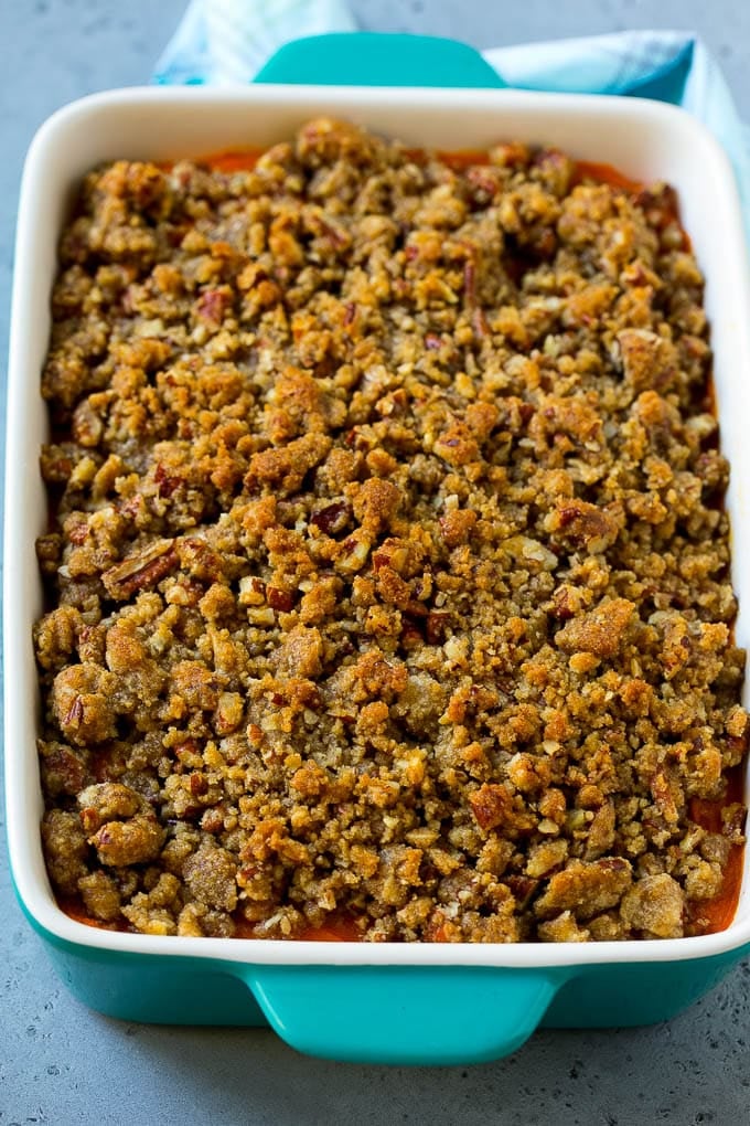 Ruth's Chris Sweet Potato Casserole Recipe | Sweet Potato Casserole | Mashed Sweet Potatoes #sweetpotatoes #casserole #thanksgiving #christmas #holidays #dinner #fuyos #sidedish A baking dish of Ruth's Chris sweet potato casserole topped with streusel.