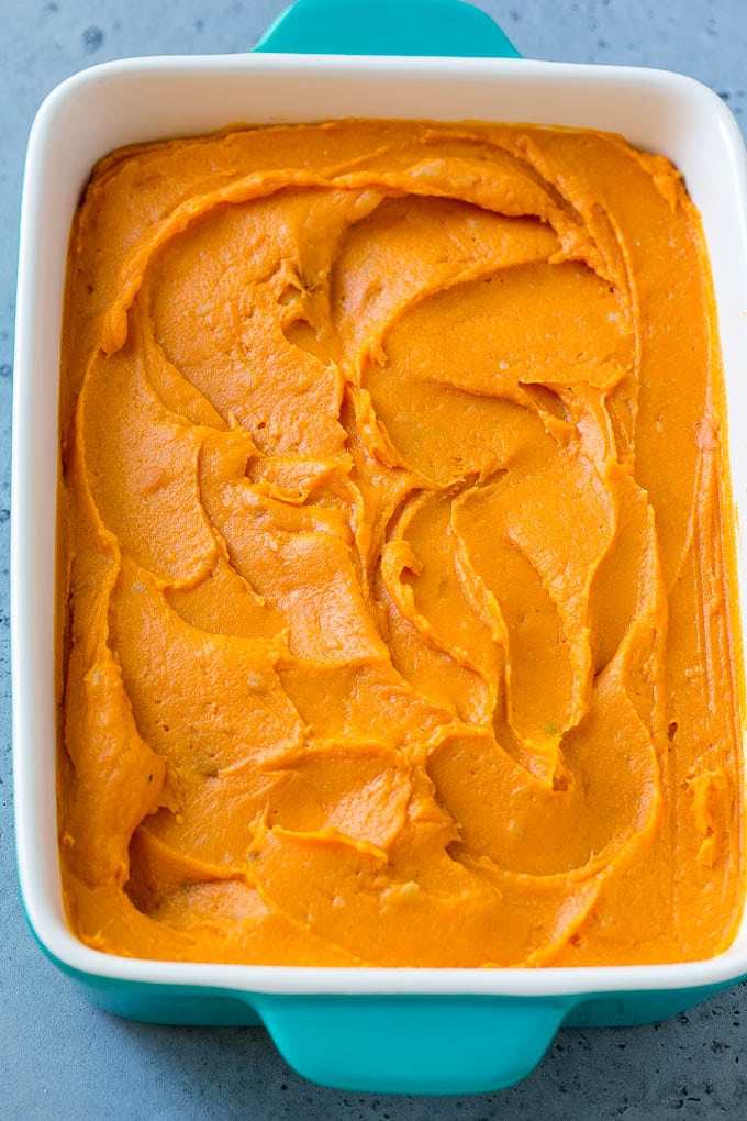 Ruth's Chris Sweet Potato Casserole Recipe | Sweet Potato Casserole | Mashed Sweet Potatoes #sweetpotatoes #casserole #thanksgiving #christmas #holidays #dinner #fuyos #sidedish A pan of mashed sweet potatoes.