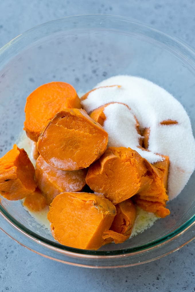 Ruth's Chris Sweet Potato Casserole Recipe | Sweet Potato Casserole | Mashed Sweet Potatoes #sweetpotatoes #casserole #thanksgiving #christmas #holidays #dinner #fuyos #sidedish Sweet potatoes, sugar and butter in a bowl.