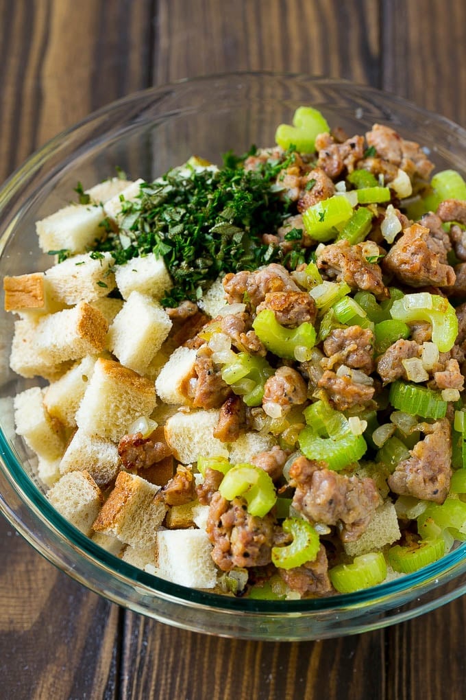 Sausage Stuffing Recipe | Thanksgiving Stuffing | Make Ahead Stuffing #stuffing #thanksgiving #sausage #sidedish #dinner #fuyos Meat, sauteed vegetables and bread cubes in a mixing bowl.