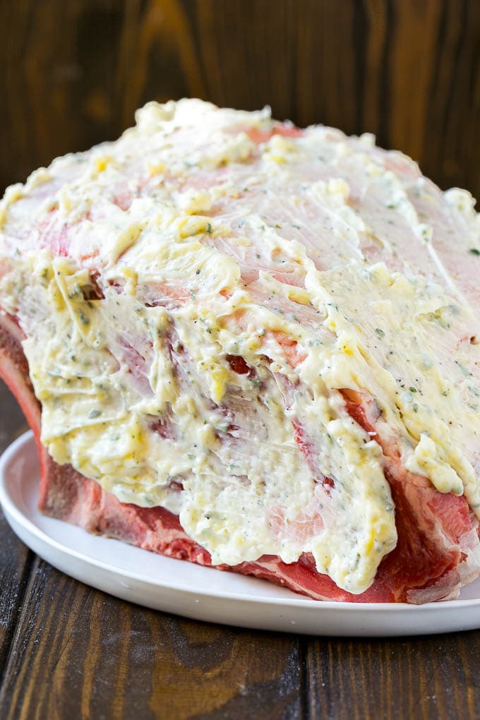 A roast coated in garlic and herb butter.
