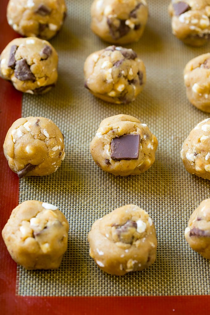 S'mores Cookies Recipe | Marshmallow Cookies #smores #marshmallow #chocolate #cookies #dessert #fuyos Balls of cookie dough on a baking sheet.