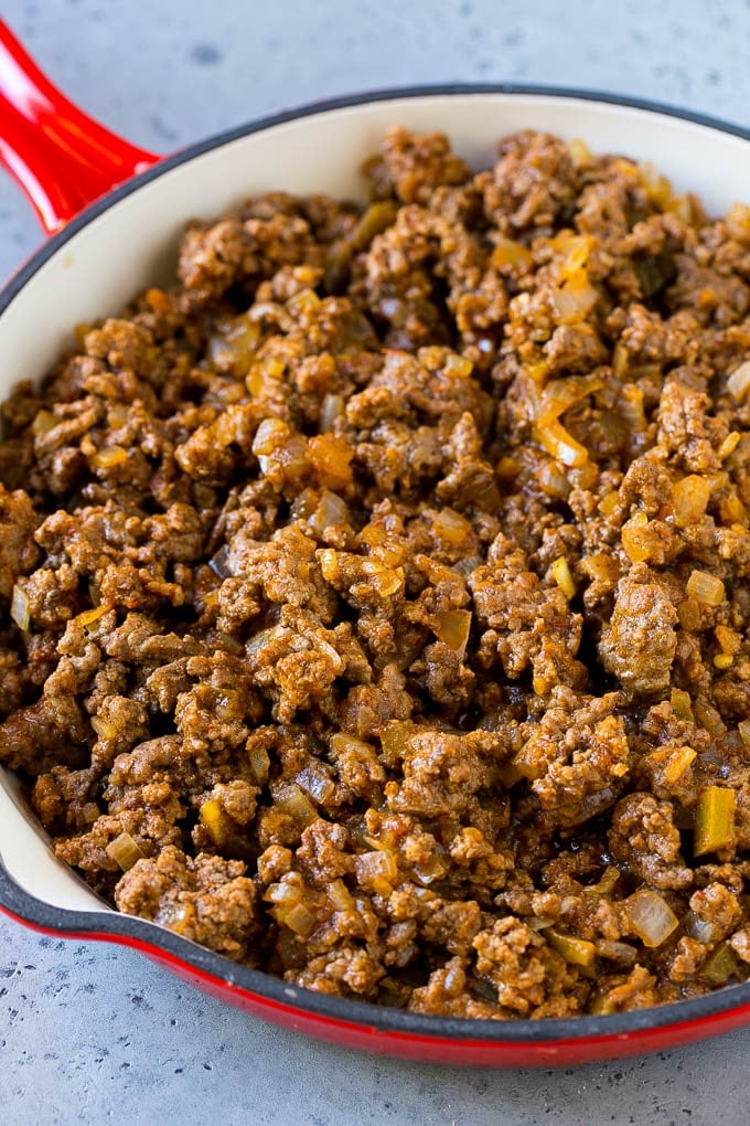 Dorito Casserole Recipe | Mexican Casserole | Beef Casserole #mexicanfood #beef #groundbeef #casserole #dinner #fuyos Ground beef, onions and salsa in a skillet.