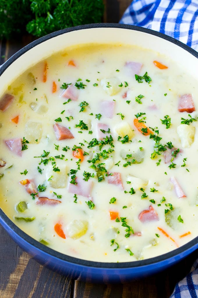 Ham and Potato Soup | Ham Soup | Potato Soup #soup #ham #potato #dinner #comfortfood #fuyos A pot of ham and potato soup with vegetables in a creamy broth, topped with parsley.