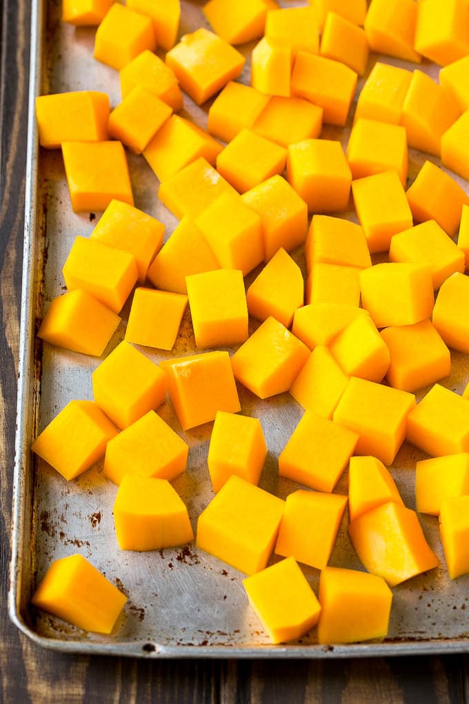 Roasted Butternut Squash Recipe | Baked Butternut Squash | Butternut Squash Side Dish #butternutsquash #squash #fall #vegetarian #dinner #fuyos Raw cubed squash on a sheet pan.