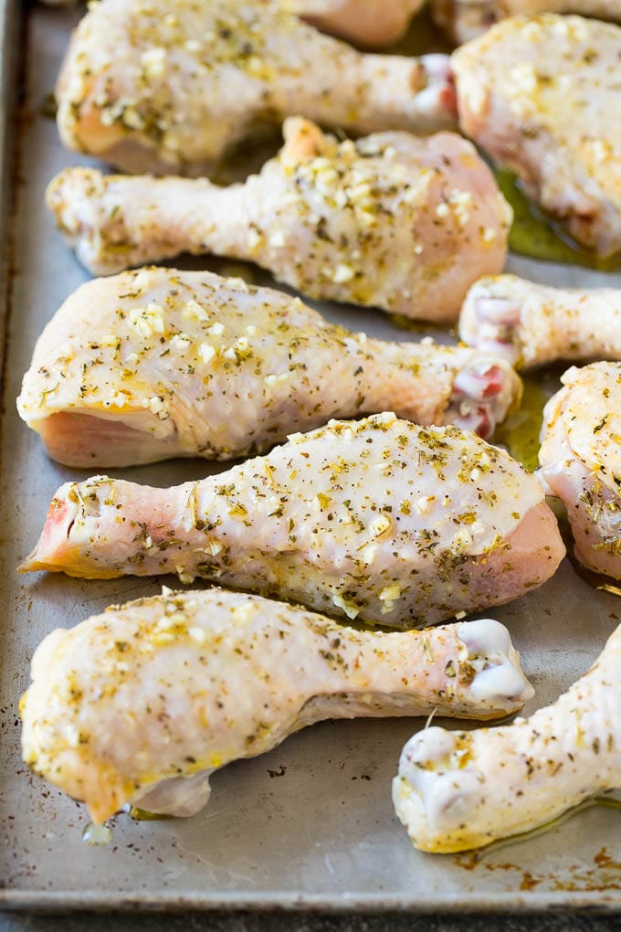 Baked Chicken Drumsticks Recipe | Roasted Chicken Drumsticks | Garlic and Herb Chicken #dinner #chicken #garlic #glutenfree #lowcarb #keto #cleaneating #fuyos Marinated chicken legs on a sheet pan, ready to go into the oven.