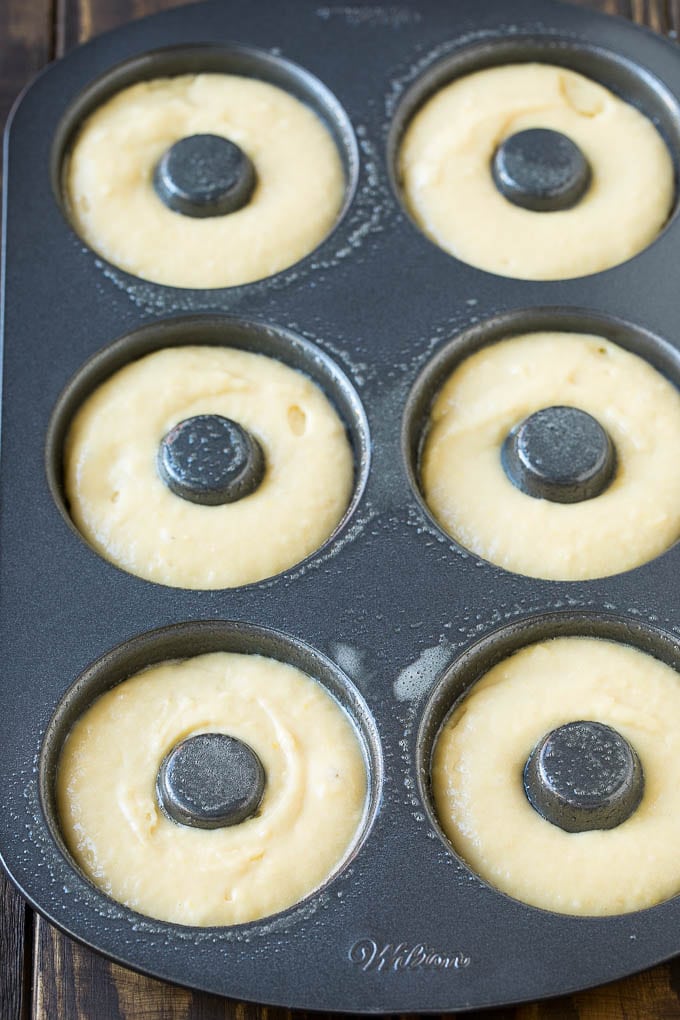 Baked Donuts Recipe | Cake Donuts | Chocolate Donuts | Sprinkle Donuts #donuts #chocolate #sprinkles #breakfast #brunch #fuyos A donut pan filled with dough.