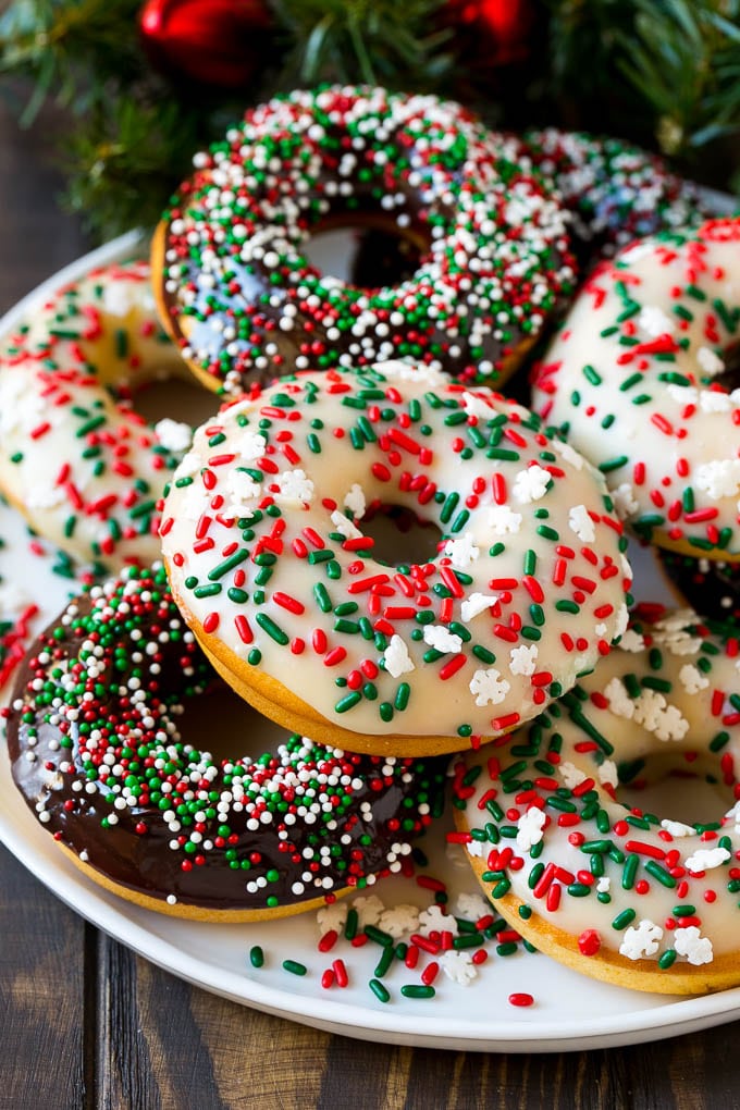Baked Donuts Recipe | Cake Donuts | Chocolate Donuts | Sprinkle Donuts #donuts #chocolate #sprinkles #breakfast #brunch #fuyos A serving plate of baked donuts frosted in dark and white chocolate and topped with sprinkles.