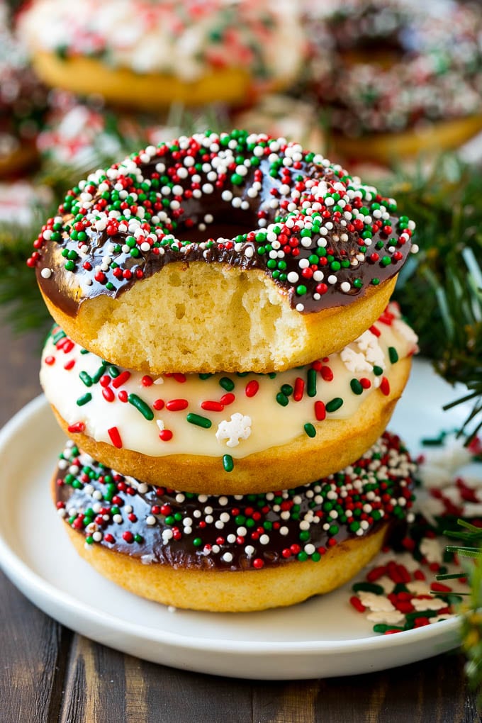 Baked Donuts Recipe | Cake Donuts | Chocolate Donuts | Sprinkle Donuts #donuts #chocolate #sprinkles #breakfast #brunch #fuyos A stack of donuts with a bite out of one.