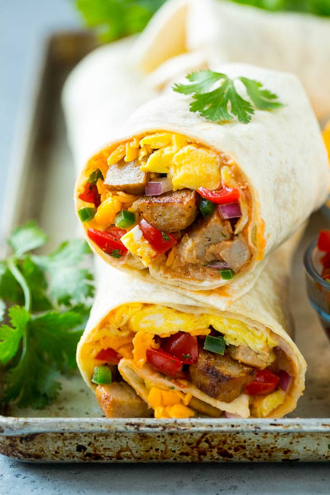 Breakfast Burrito Recipe | Sausage Breakfast Burrito #breakfast #sausage #eggs #burrito #fuyos A cross section of a breakfast burrito filled with eggs, sausage, beans and cheese.