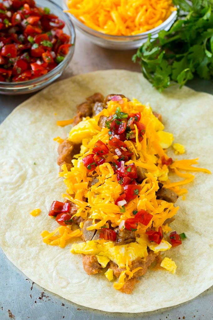Breakfast Burrito Recipe | Sausage Breakfast Burrito #breakfast #sausage #eggs #burrito #fuyos A flour tortilla topped with eggs, sausage, cheese and pico de gallo salsa.