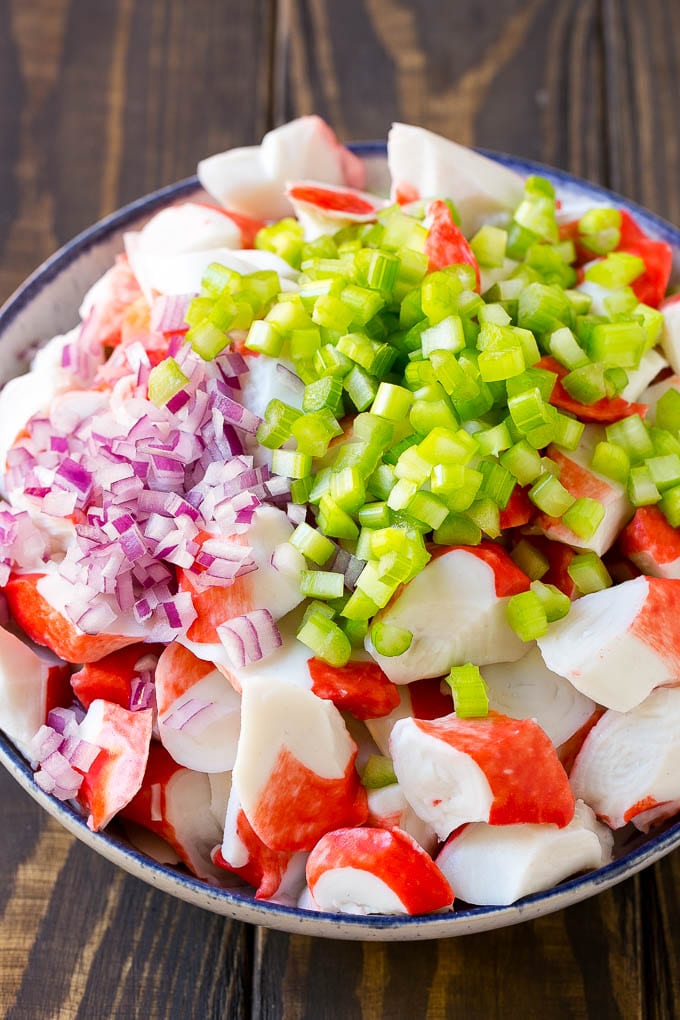 Crab Salad Recipe | Seafood Salad | Deli Salad #crab #salad #seafood #lowcarb #keto #lunch #dinner #fuyos Imitation crab, celery and red onion in a serving bowl.