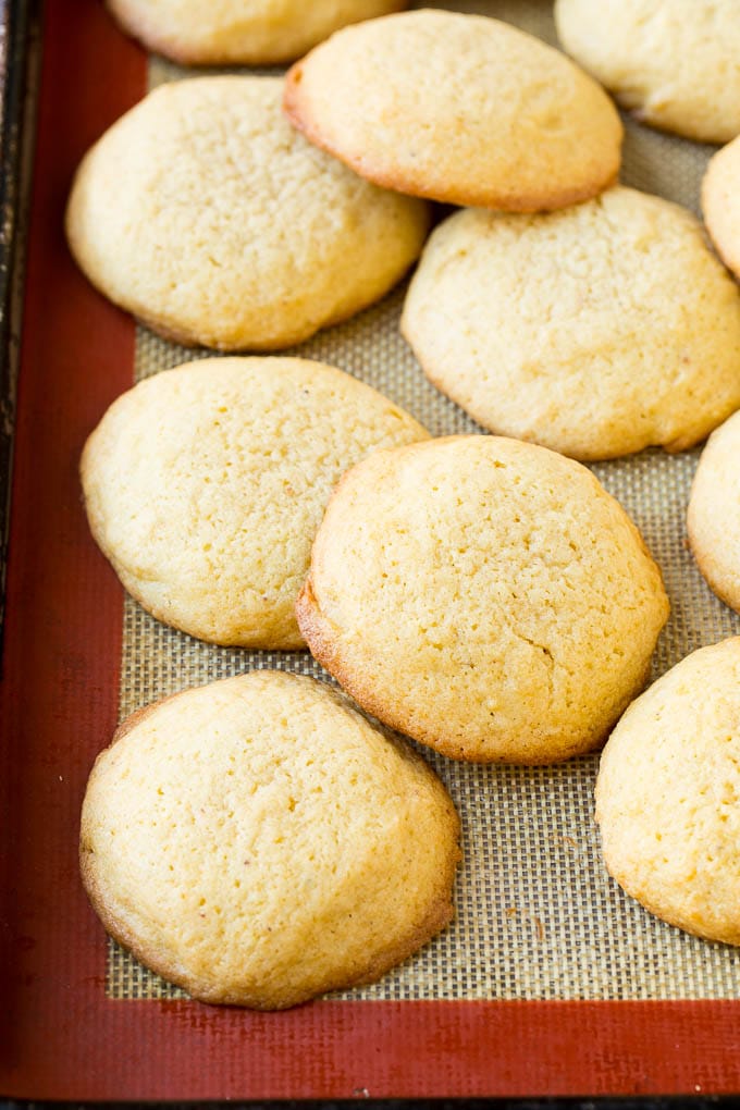 Baked eggnog cookies on a sheet pan.