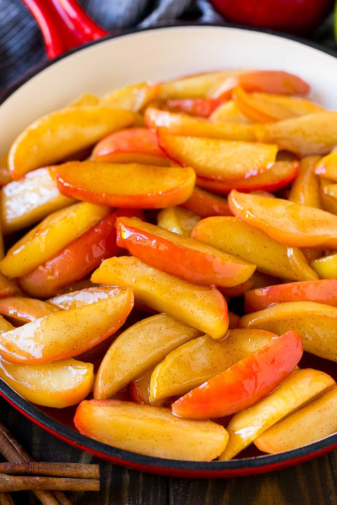 Fried Apples Recipe | Sauteed Apples | Cinnamon Sugar Apples #apples #cinnamon #sugar #sidedish #dessert #fuyos #fall Southern fried apples coated in butter, cinnamon and sugar in a red skillet.
