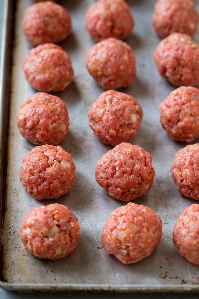 Sweet and Sour Meatballs Recipe | Slow Cooker Meatballs | Crockpot Meatballs | Cocktail Meatballs #meatballs #beef #slowcooker #crockpot #dinner #appetizer #fuyos Homemade meatballs on a sheet pan.