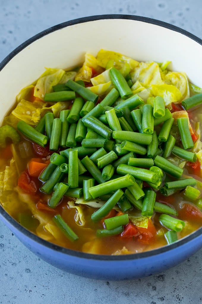 Cabbage Soup Recipe | Vegetable Soup | Veggie Soup | Healthy Soup #soup #healthy #cleaneating #cabbage #vegetables #veggies #dinner #fuyos Green beans in a pot of cooked veggies.