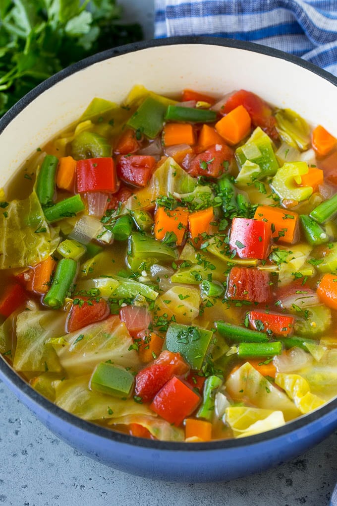 Cabbage Soup Recipe | Vegetable Soup | Veggie Soup | Healthy Soup #soup #healthy #cleaneating #cabbage #vegetables #veggies #dinner #fuyos A pot of cabbage soup with carrots, celery, bell peppers and green beans.