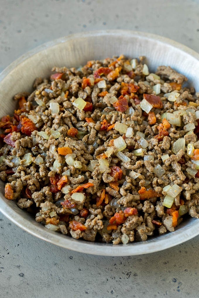 Ground beef, onions and bacon in a tin.