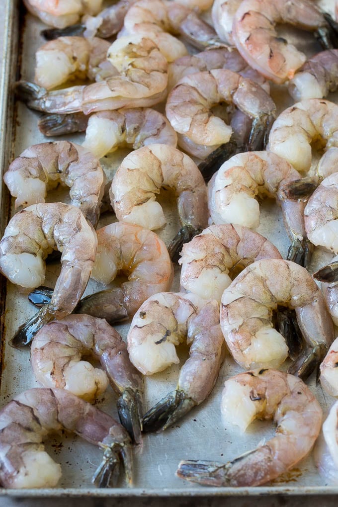 Coconut Shrimp Recipe | Fried Shrimp | Shrimp Appetizer #shrimp #coconut #appetizer #seafood #dinner #fuyos Large raw tail-on shrimp arranged on a sheet pan.