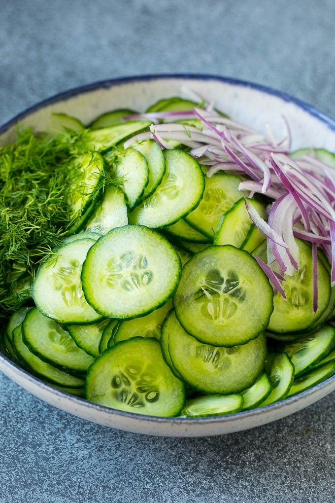 Cucumber Salad Recipe | Cucumber Dill Salad | Cucumber Recipe #cucumbers #salad #glutenfree #sidedish #fuyos Ingredients including red onion and dill in a bowl.