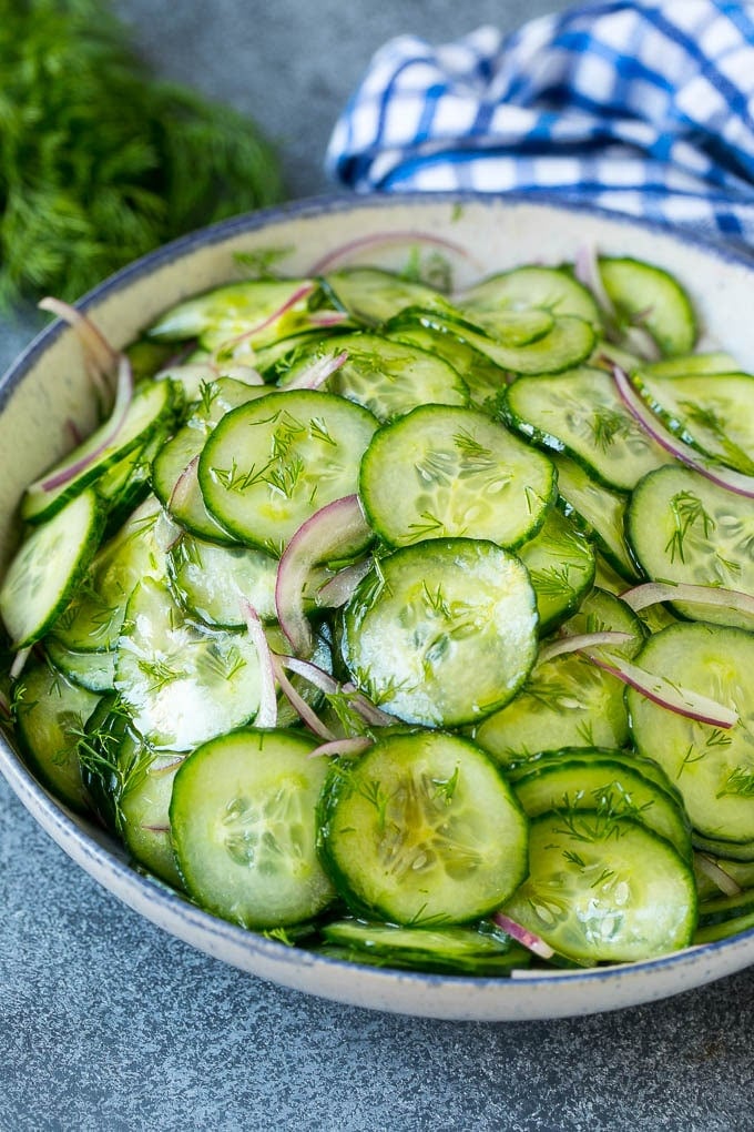 Cucumber Salad Recipe | Cucumber Dill Salad | Cucumber Recipe #cucumbers #salad #glutenfree #sidedish #fuyos A bowl of cucumber salad with red onion, thinly sliced cucumbers and chopped dill.