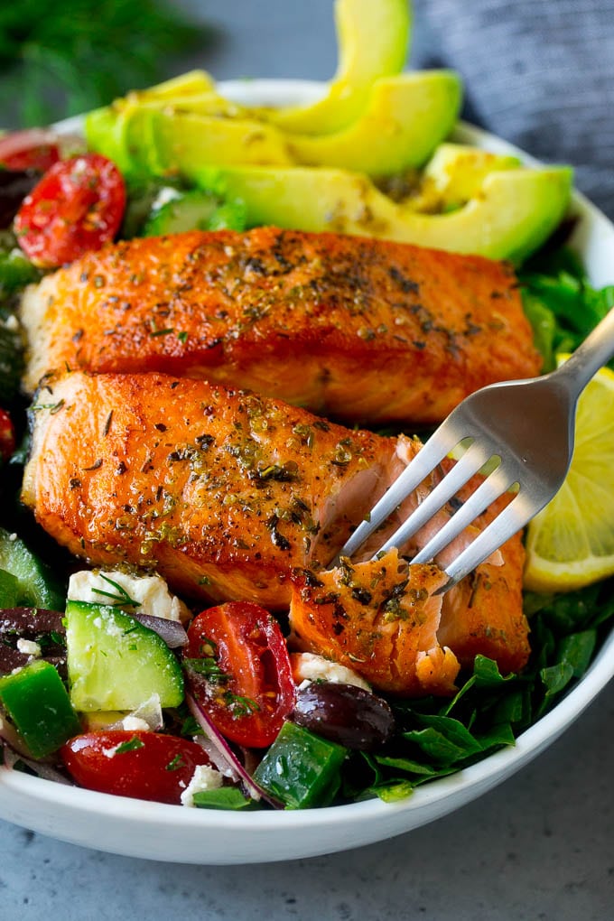 Greek Salmon Salad Recipe | Low Carb Salmon Recipe | Salmon Salad #salmon #seafood #fish #lowcarb #keto #lunch #fuyos #healthy A fork cutting into a salmon fillet in Greek salmon salad.